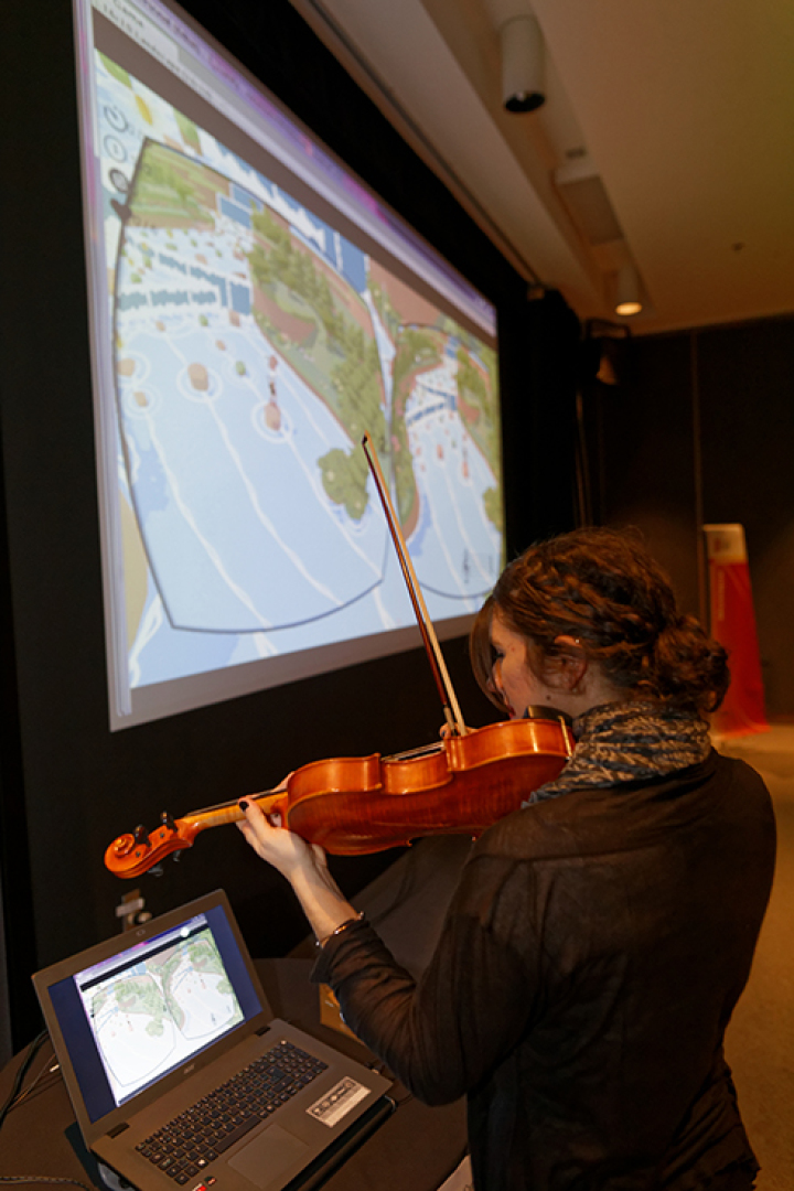 photo of the videogame being controlled via the violin notes