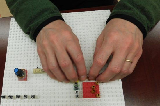 Photo of visually impaired user using tangible prototyping tools